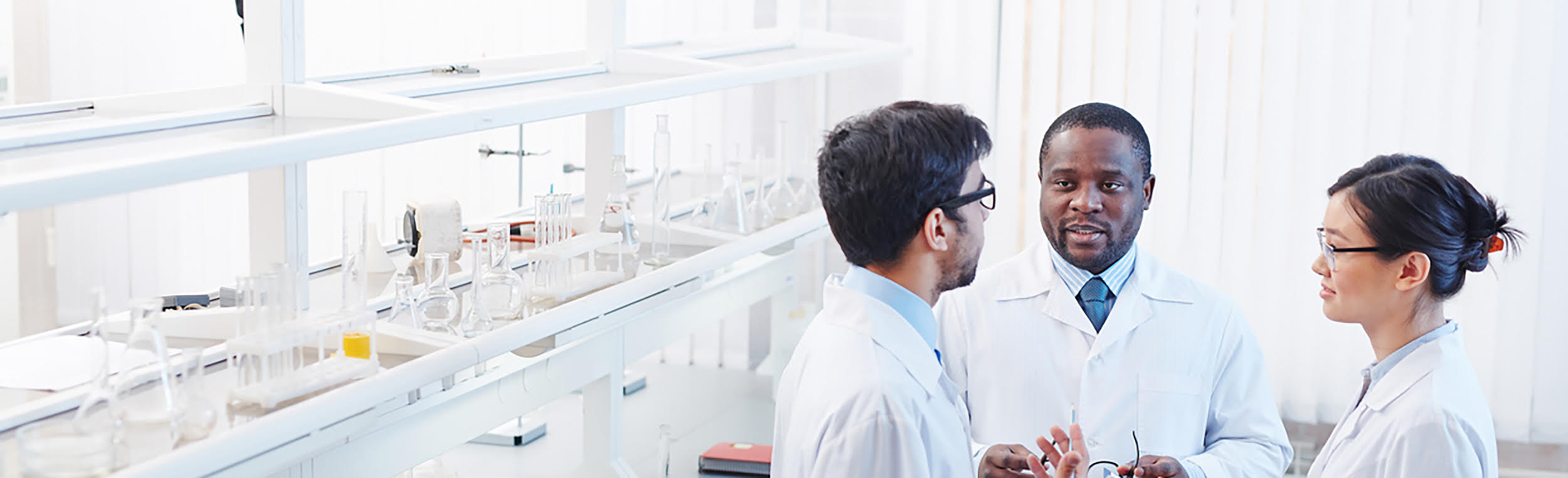 Scientists discussing in a chemitry lab
